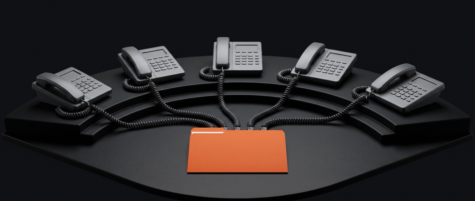 Five identical telephones wired to a single orange lead file
